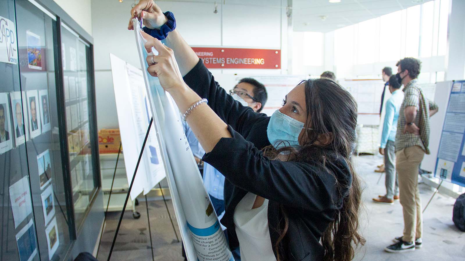 students set up posters at 6th annual berg symposium