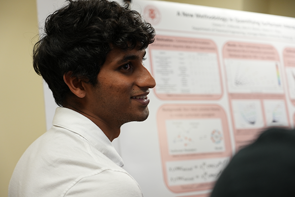 Chetan Chilkunda in front of his research poster