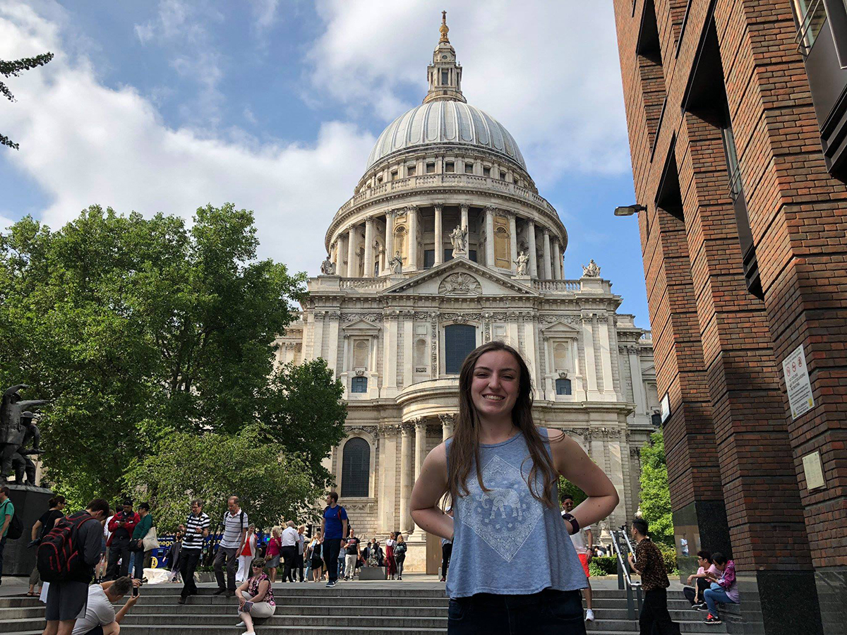 A young woman in front of a building in London