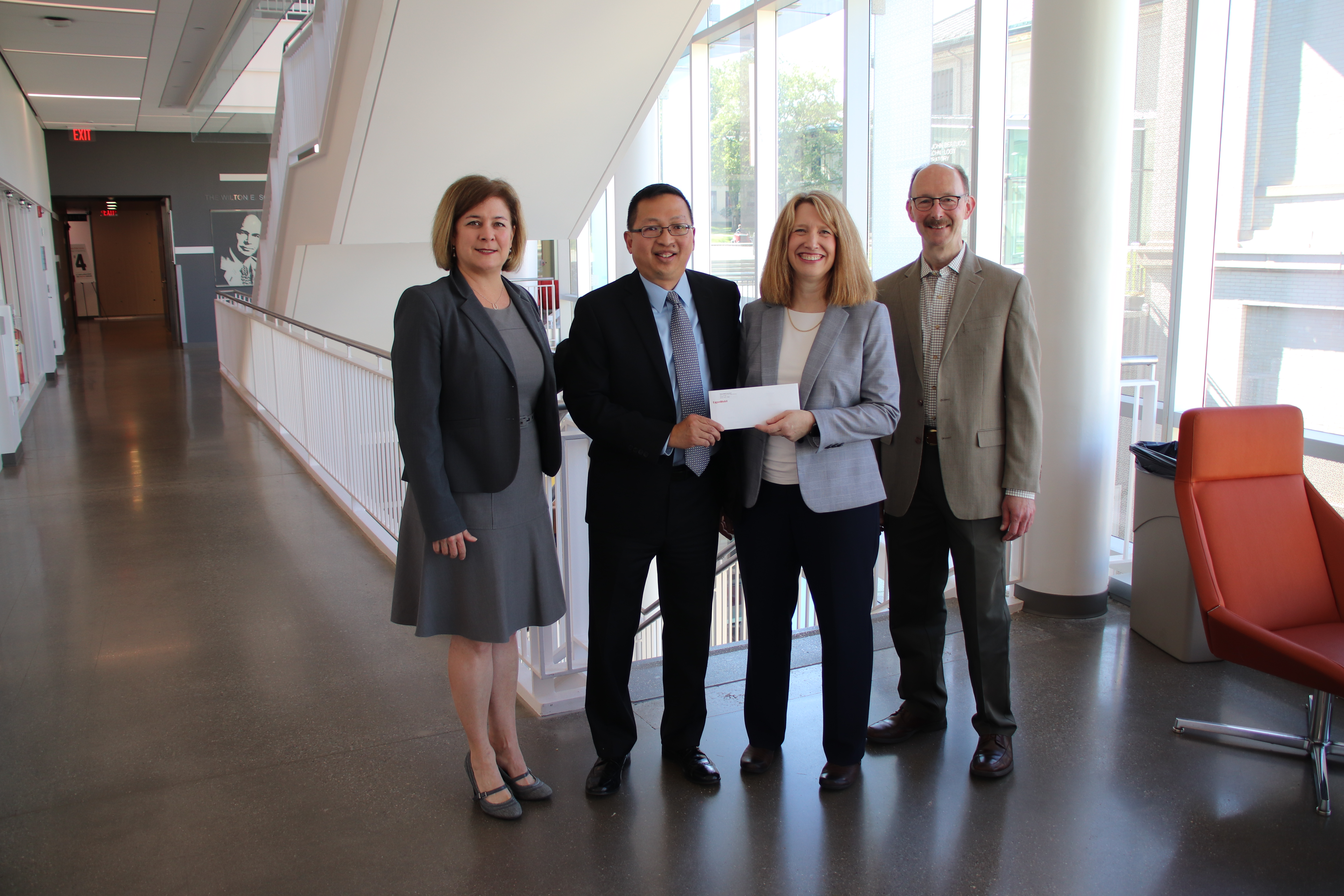 William Wang poses with Anne Robinson and other university representatives