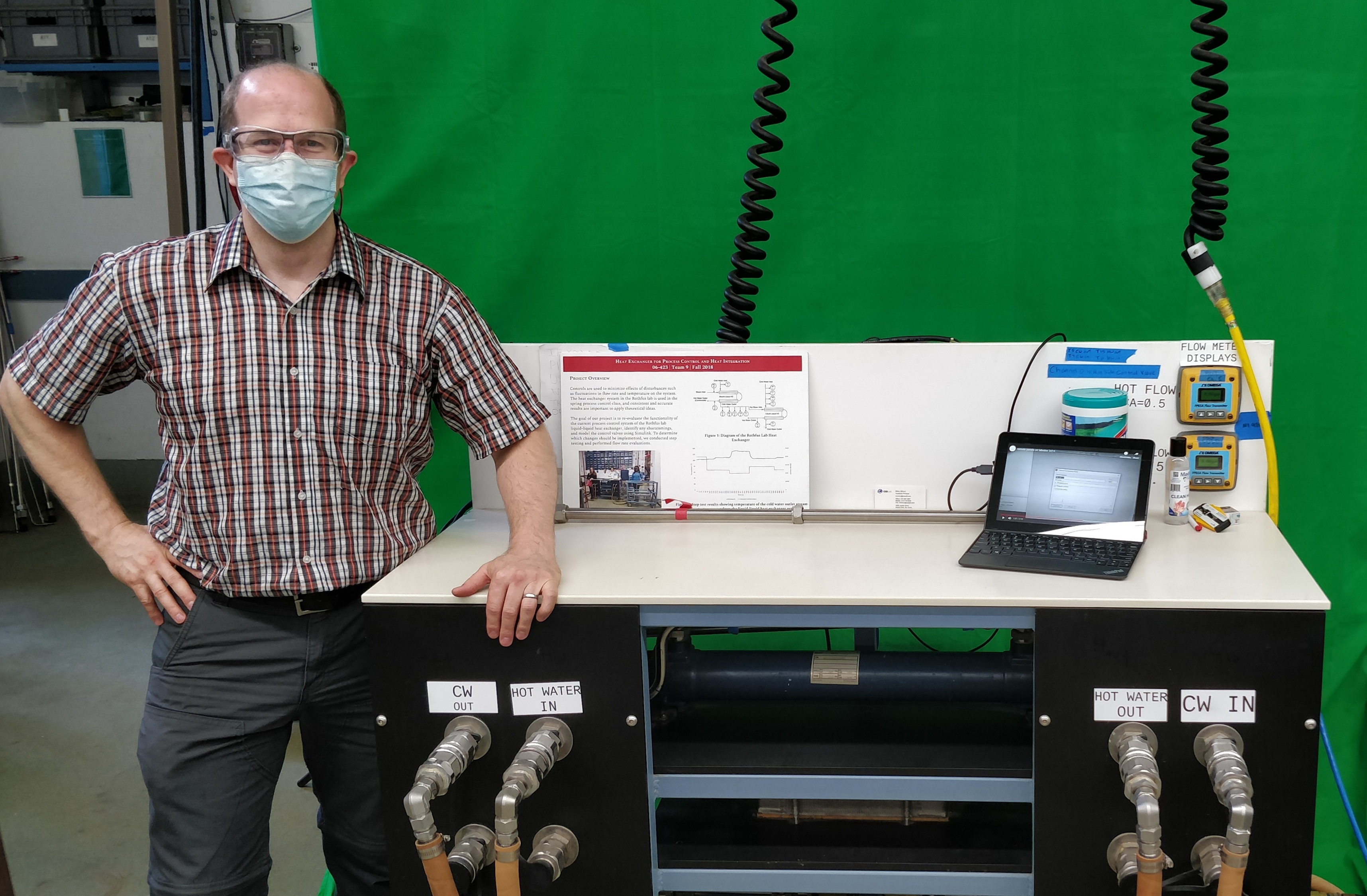 Lab Instructor Matt Cline stands in front of remotely controlled laboratory equipment.