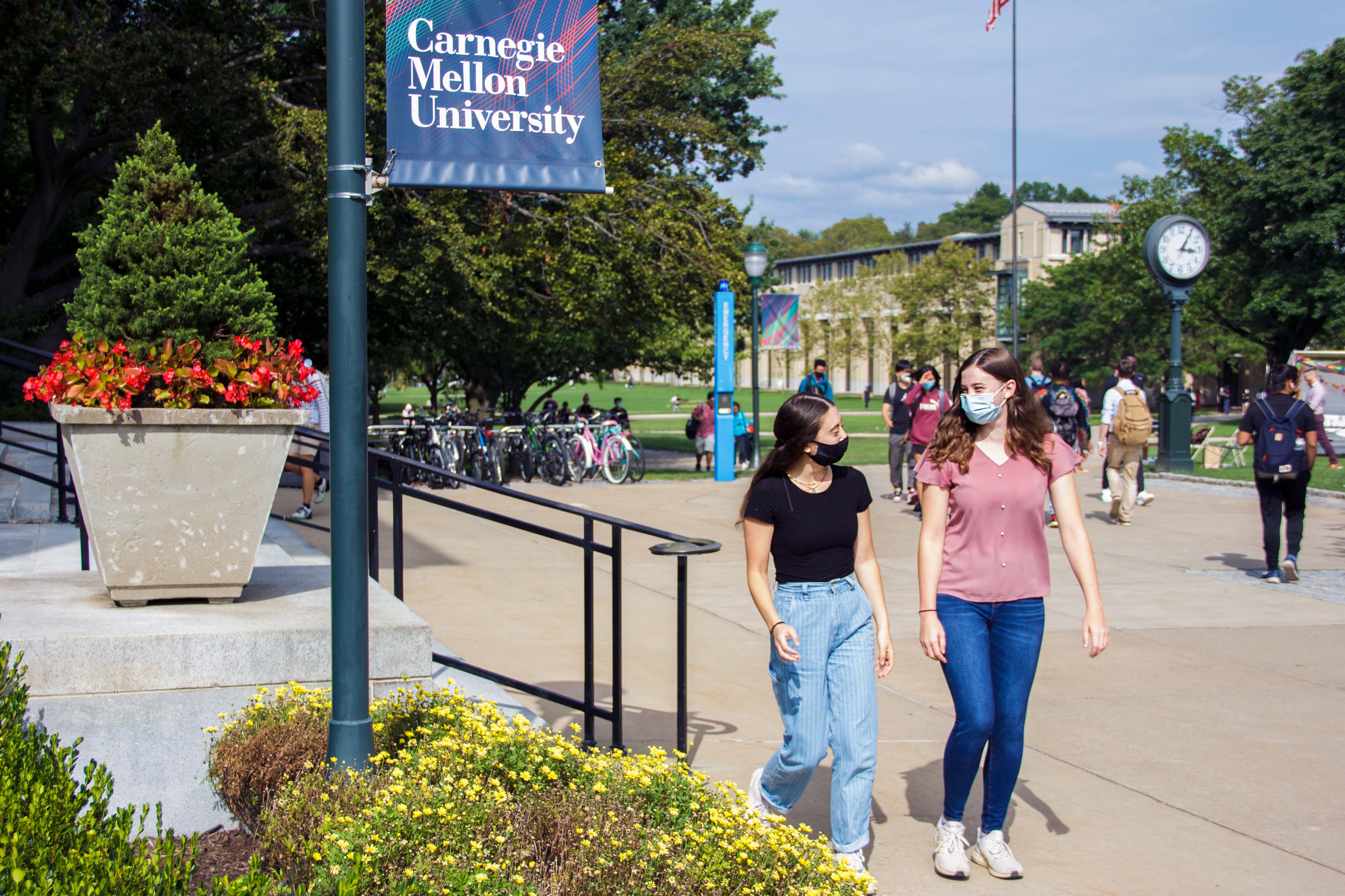 (L to R) Lynn Rushkin and Katelyn Parson walking past Doherty Hall on CMU's Pittsburgh campus