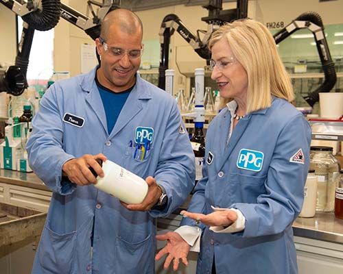 Rebecca Liebert works with engineer in facility at PPG