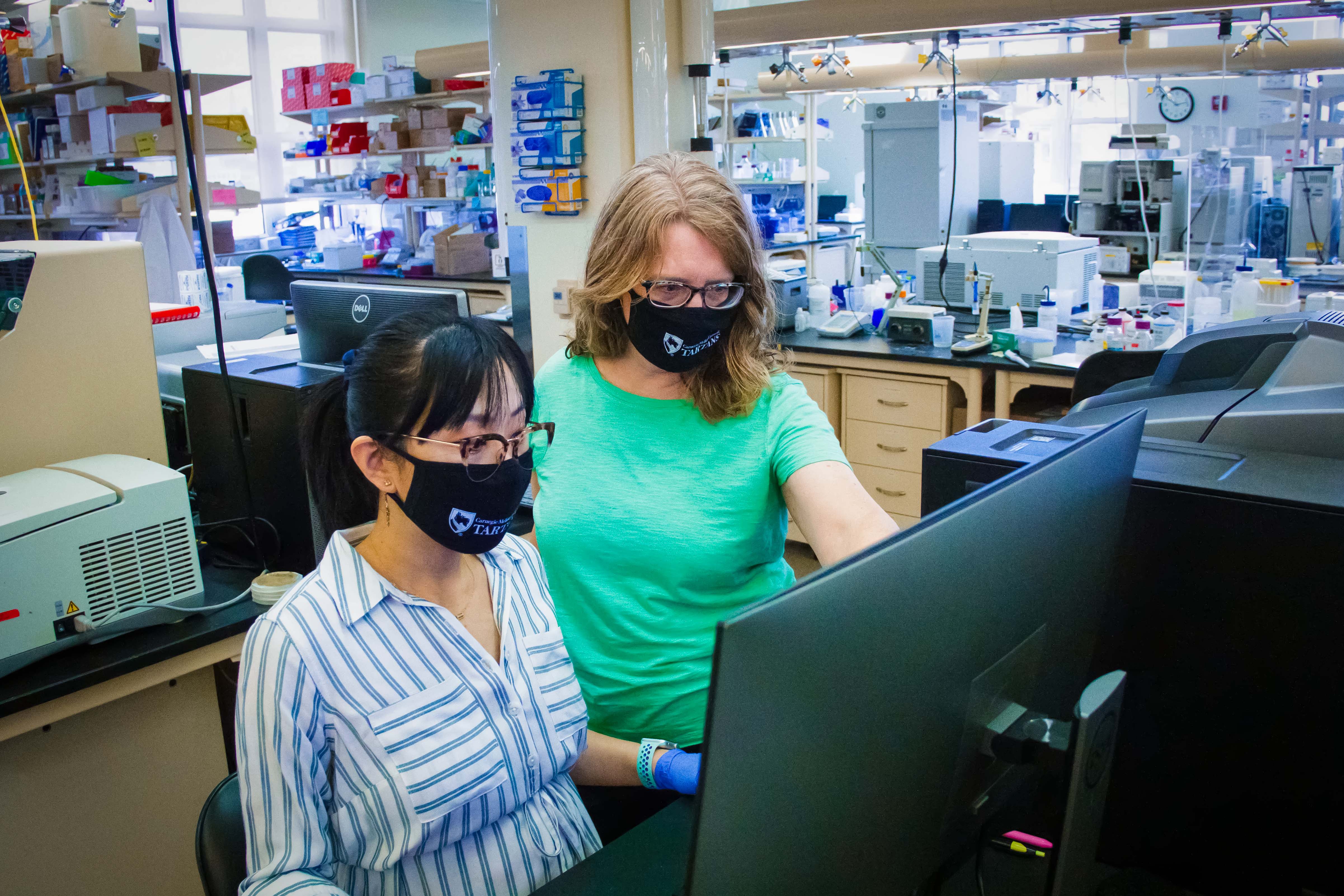 Dr. Anne Robinson and Ph.D. student Liqing Song review data in a lab at CMU's Doherty Hall