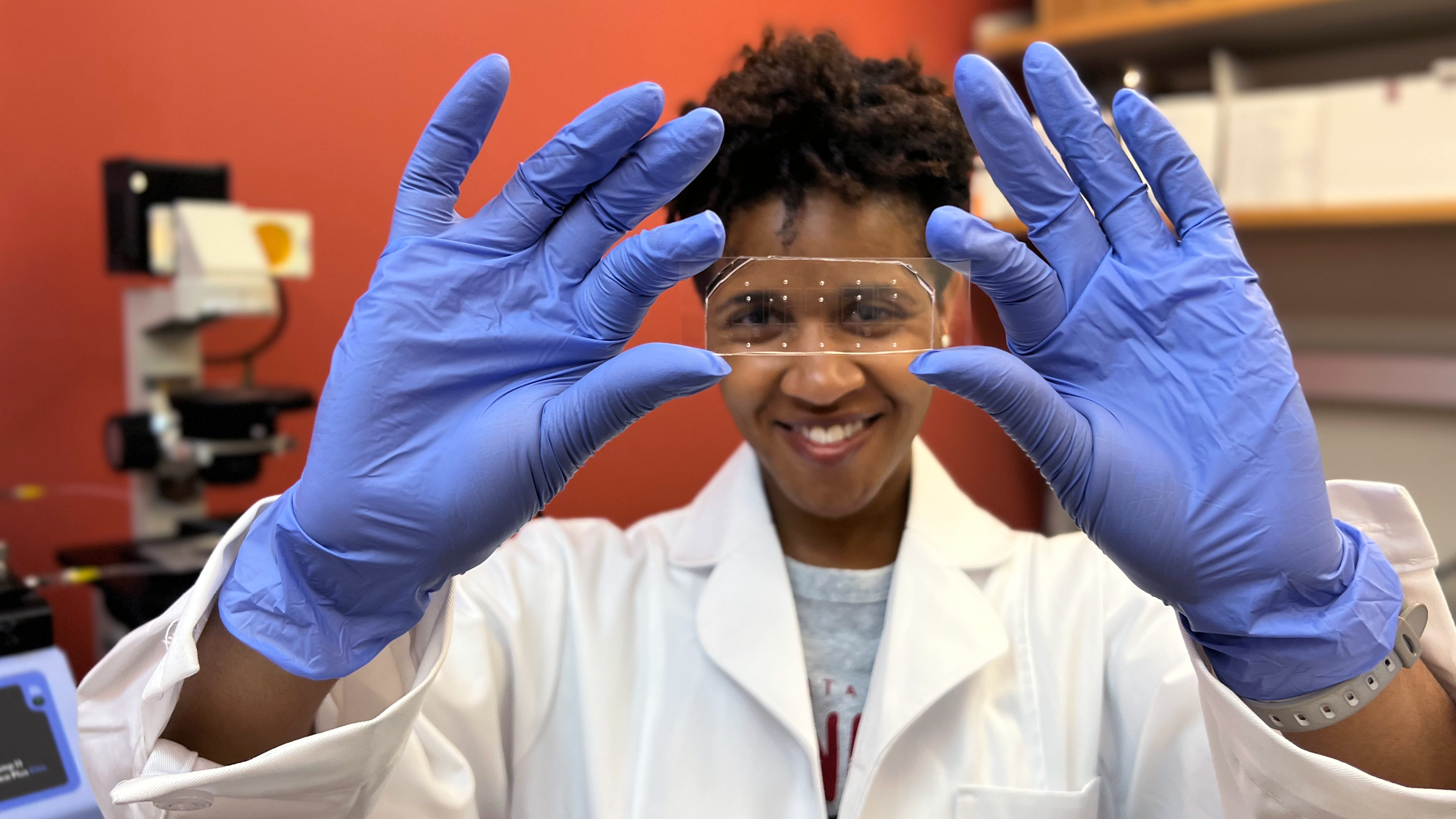 Corine Jackman looks through microscope slide 