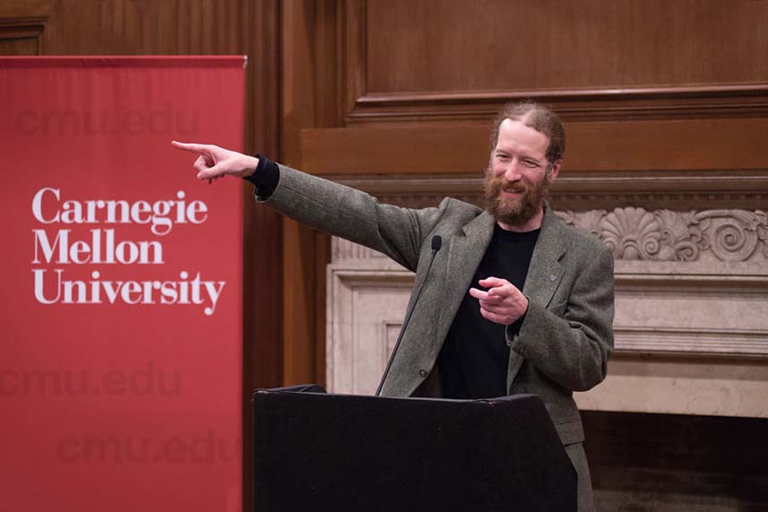 Neil Donahue giving at lecture with Carnegie Mellon University sign behind him