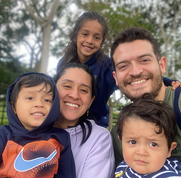 Hector Perez with his wife and three children outside in front of trees