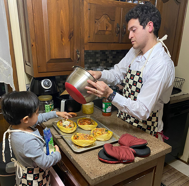 Hector Perez and his child cooking in their kitchen