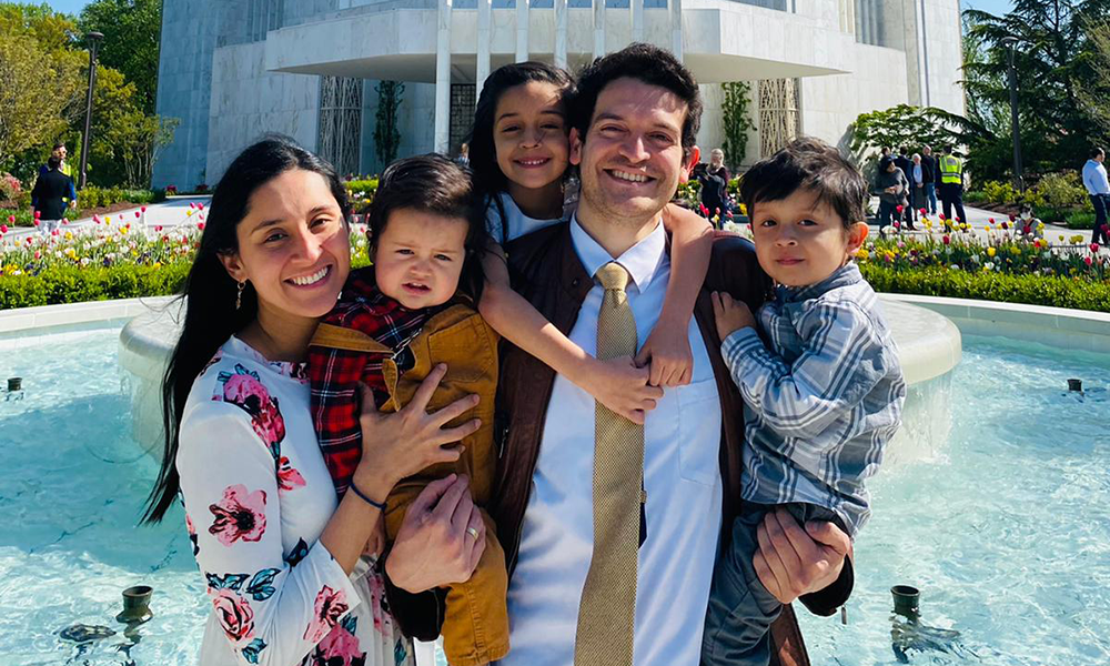 Hector Perez with his wife and three children, standing outside by a fountain