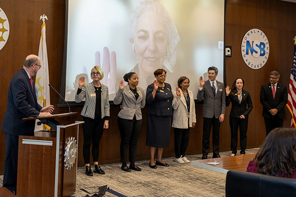 Marvi Matos and other new members of the National Science Board stand with right hands raised at their swearing in ceremony