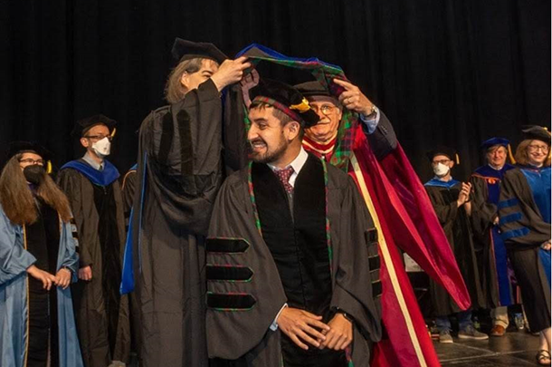 David Bernal Neira receiving his Ph.D. hood from Lynn Walker and Ignacio Grossmann