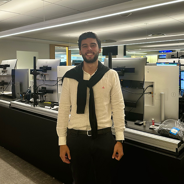 Daniel Ovalle Varela standing in a room full of computer workstations