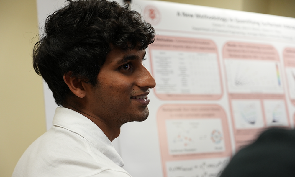 Chetan Chilkunda in front of his research poster.