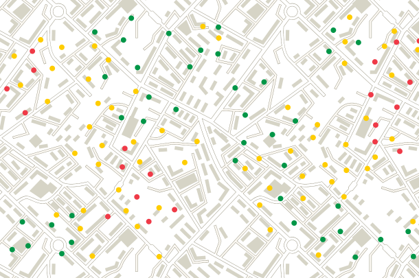 A street map with rectangular icons representing buildings. Red, yellow, and green dots are scattered across the map.
